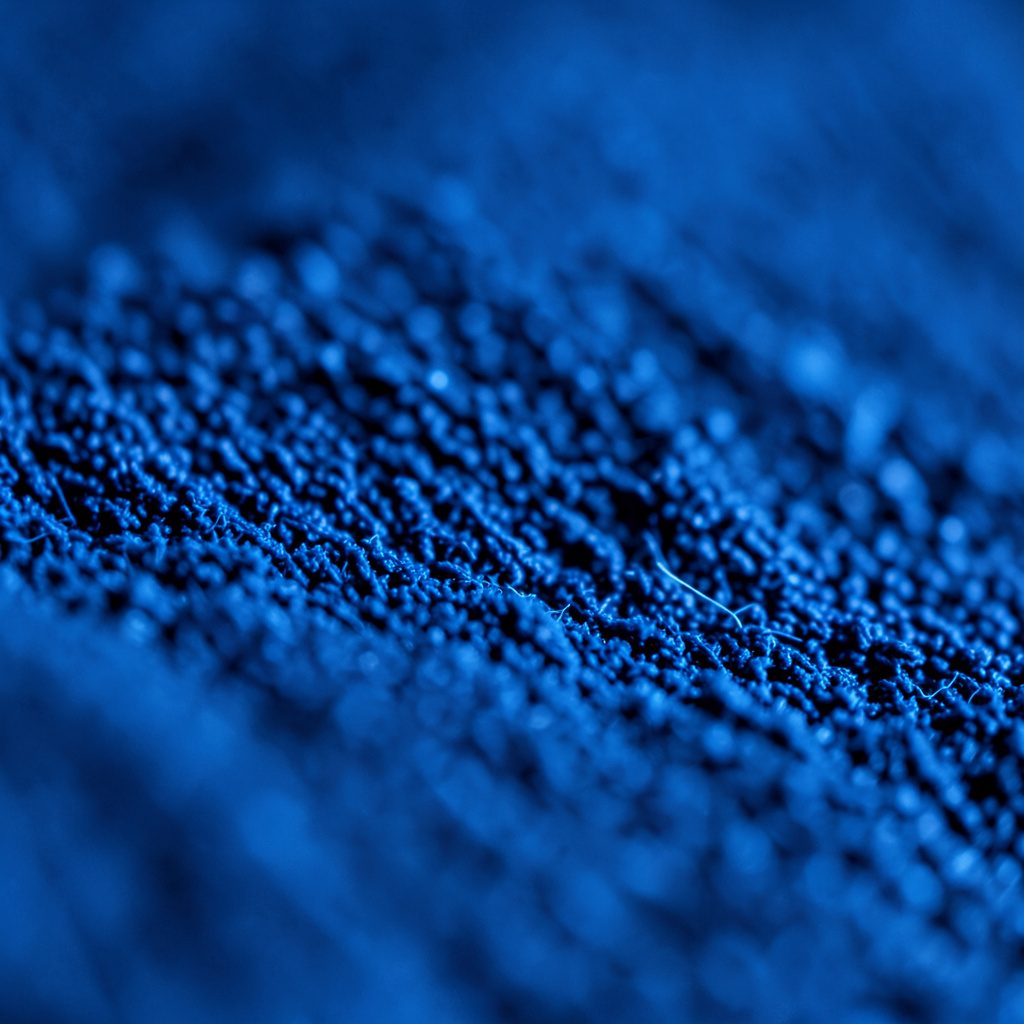 Sleek dark board material with a glossy finish and faint directional grain pattern